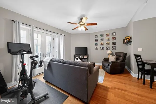 a living room with furniture a flat screen tv and a large window