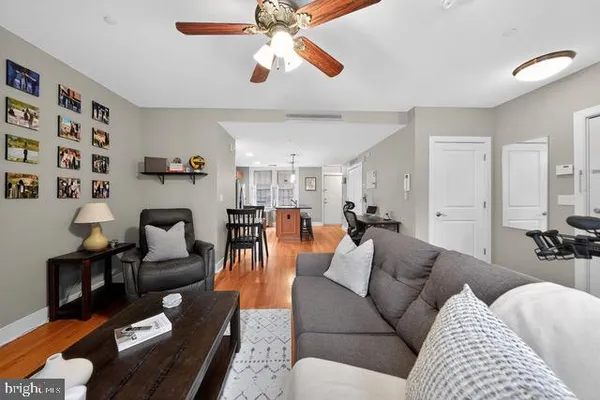 a living room with furniture and a chandelier