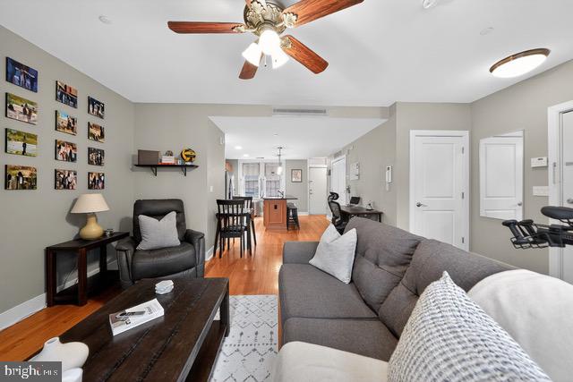 4300 Spruce Street, Unit B304 Philadelphia, PA 19104 - Photo 6 of 26 a living room with furniture and a chandelier