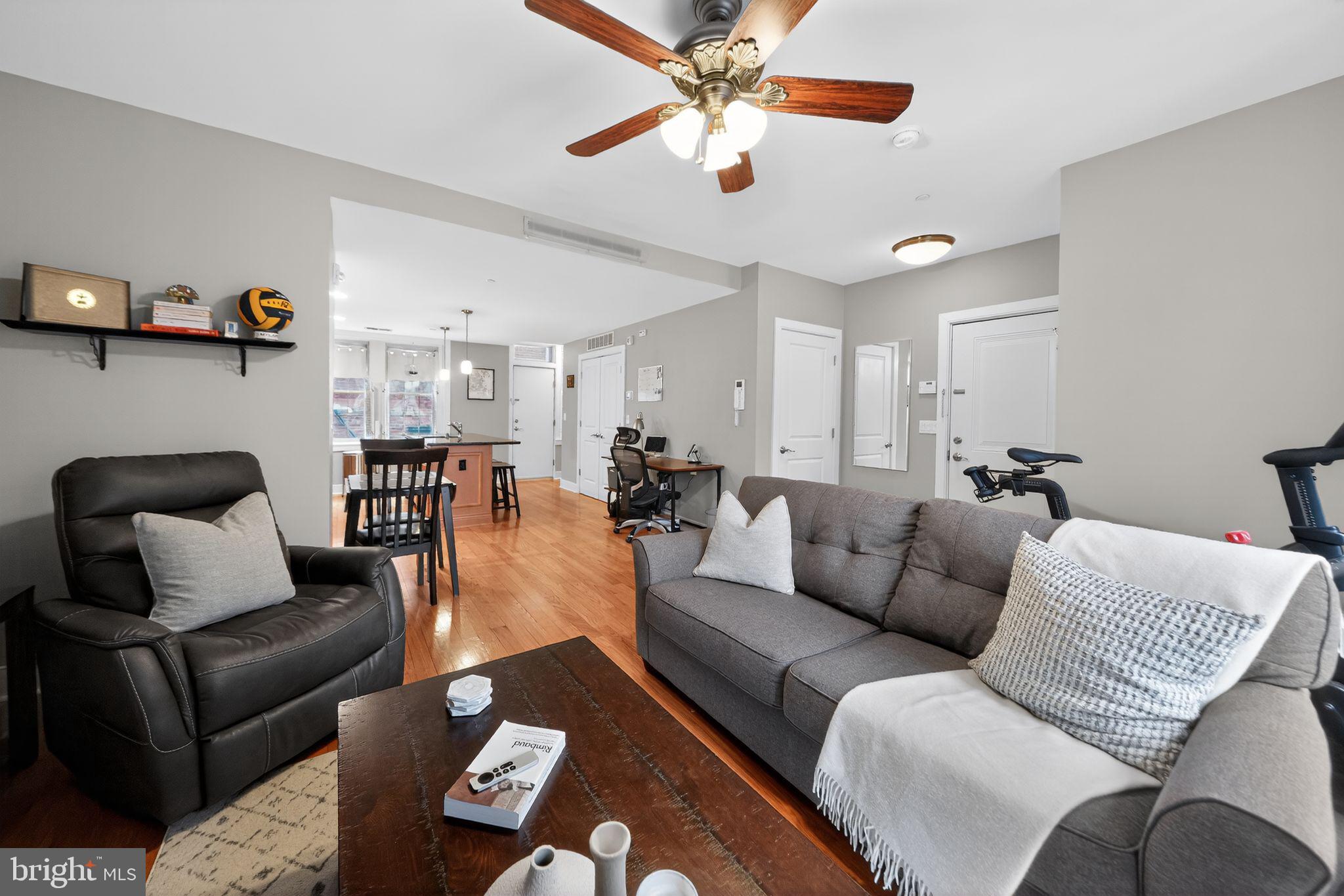 4300 Spruce Street, Unit B304 Philadelphia, PA 19104 - Photo 8 of 26 a living room with furniture and a chandelier