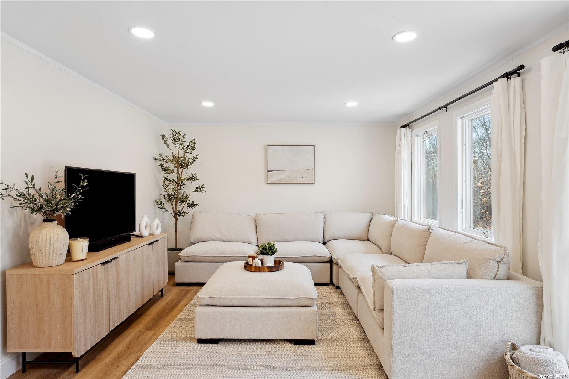 28 Argonne Road West Hampton Bays, NY 11946 - Photo 5 of 24 a living room with furniture and a flat screen tv
