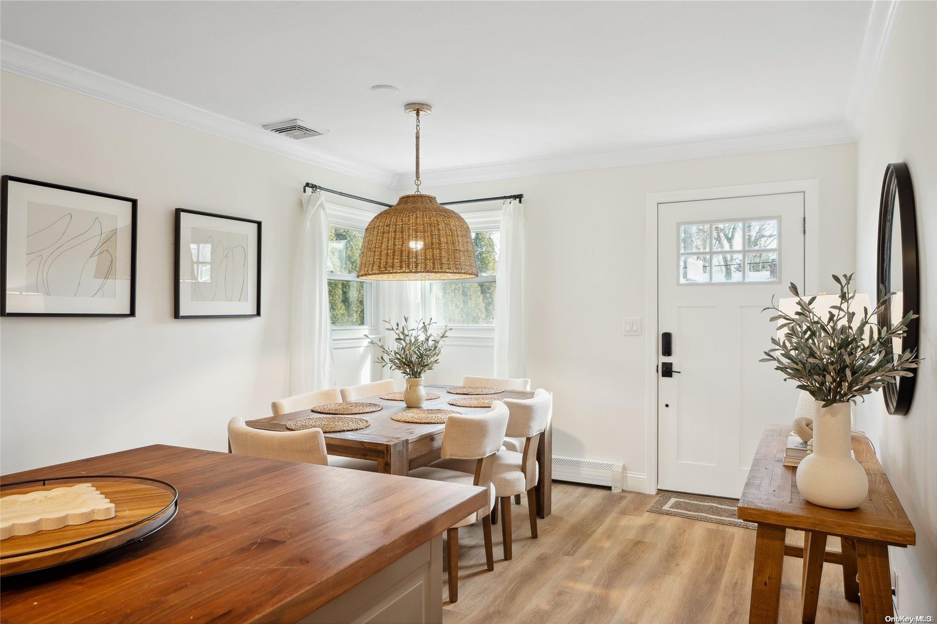28 Argonne Road West Hampton Bays, NY 11946 - Photo 8 of 24 a view of a dining room with furniture and wooden floor