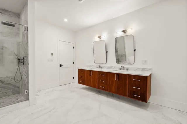 a bathroom with a white bath tub a toilet and a shower