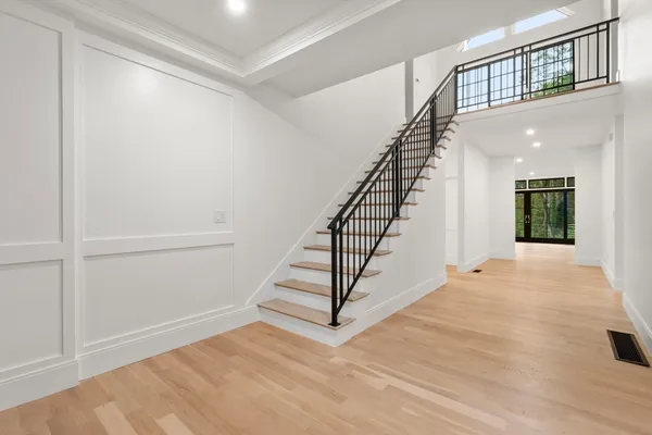 a view of entryway and hall with wooden floor