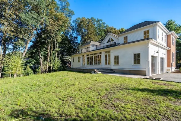 a front view of a house with a yard and a garage