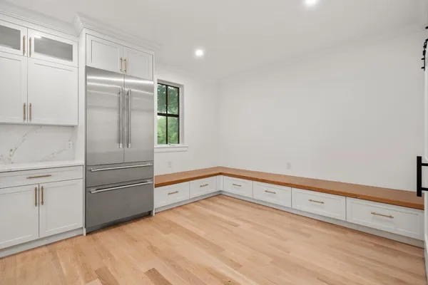 a kitchen with a refrigerator and window
