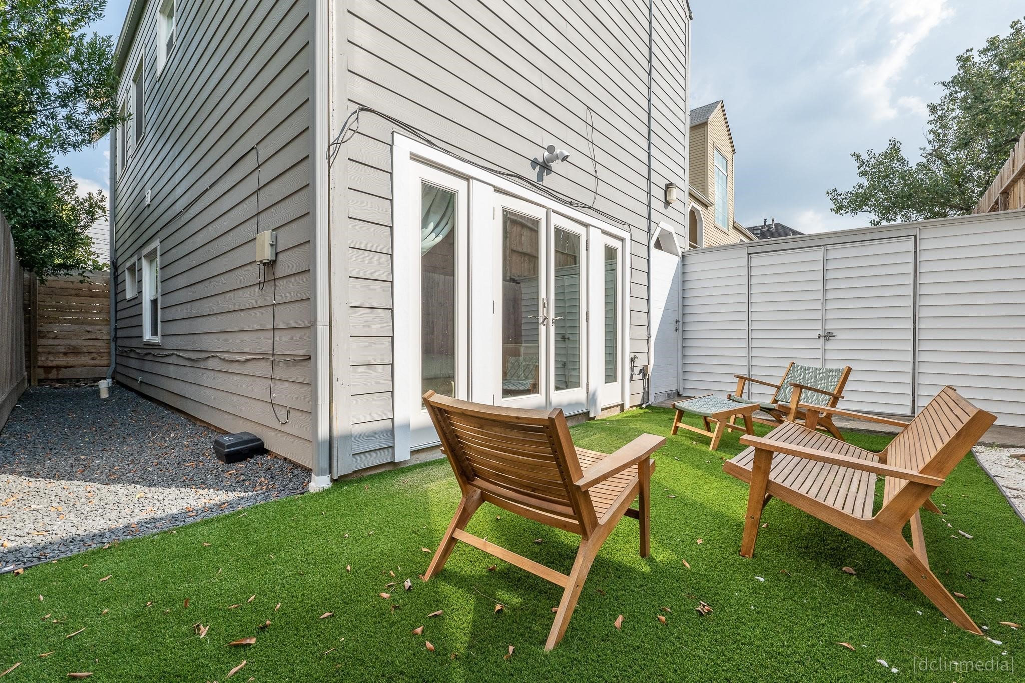 2002 Norfolk Street, Unit A Houston, TX 77098 - Photo 2 of 35 a backyard of a house with table and chairs