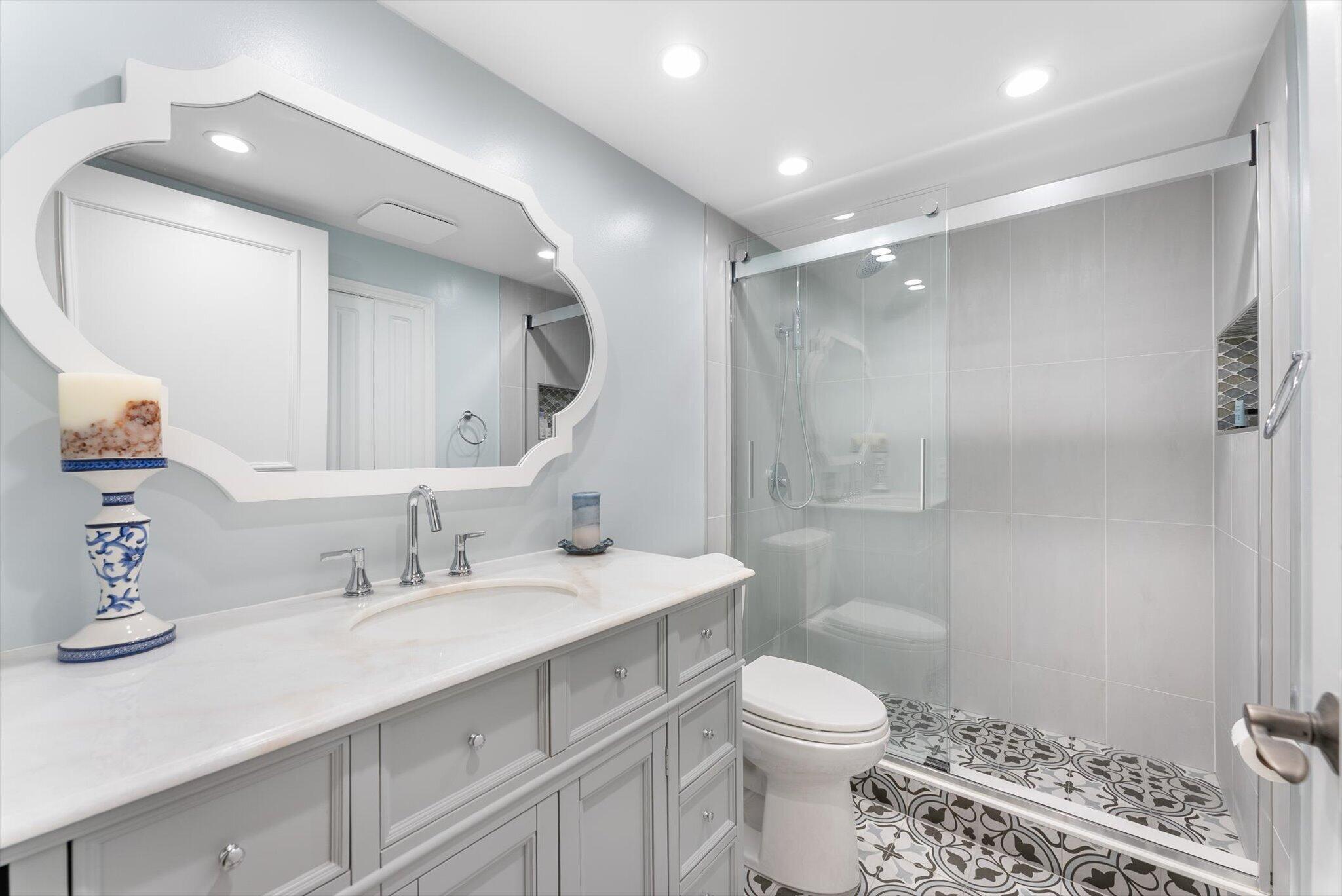 6420 Boca Del Mar Drive, Unit 201 Boca Raton, FL 33433 - Photo 15 of 45 a bathroom with a sink toilet a mirror and shower