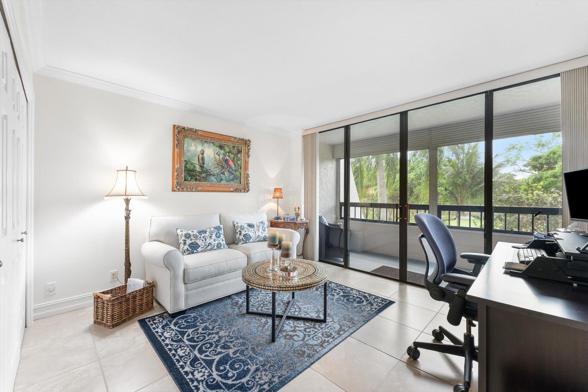 6420 Boca Del Mar Drive, Unit 201 Boca Raton, FL 33433 - Photo 16 of 45 a living room with furniture a rug and a large window
