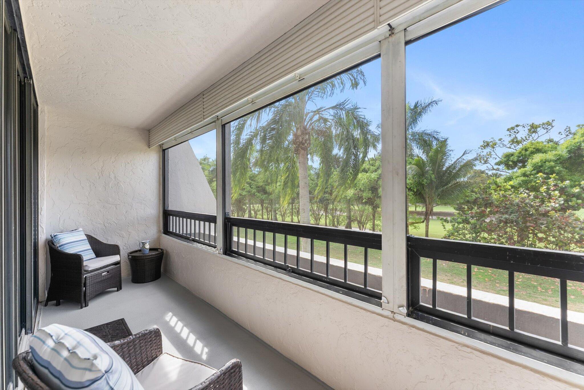 6420 Boca Del Mar Drive, Unit 201 Boca Raton, FL 33433 - Photo 18 of 45 a view of a porch with furniture and floor to ceiling window