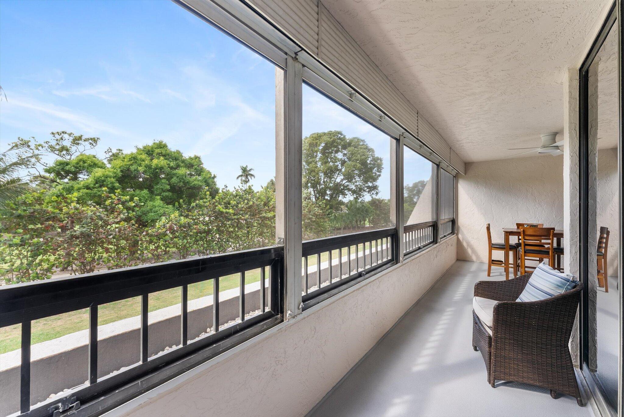 6420 Boca Del Mar Drive, Unit 201 Boca Raton, FL 33433 - Photo 19 of 45 a balcony with chairs and wooden floor