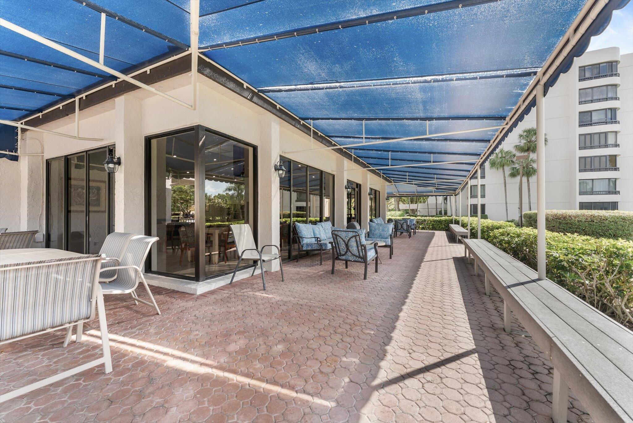 6420 Boca Del Mar Drive, Unit 201 Boca Raton, FL 33433 - Photo 28 of 45 a view of a patio with table and chairs and wooden floor