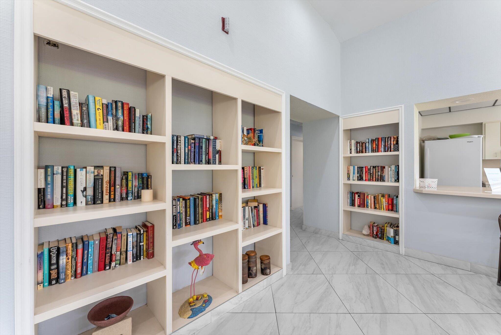 6420 Boca Del Mar Drive, Unit 201 Boca Raton, FL 33433 - Photo 33 of 45 a living room with lots of books