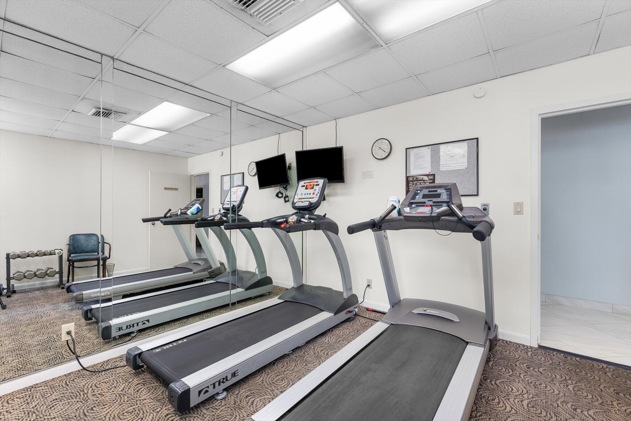 6420 Boca Del Mar Drive, Unit 201 Boca Raton, FL 33433 - Photo 35 of 45 a room with gym equipment and a mirror
