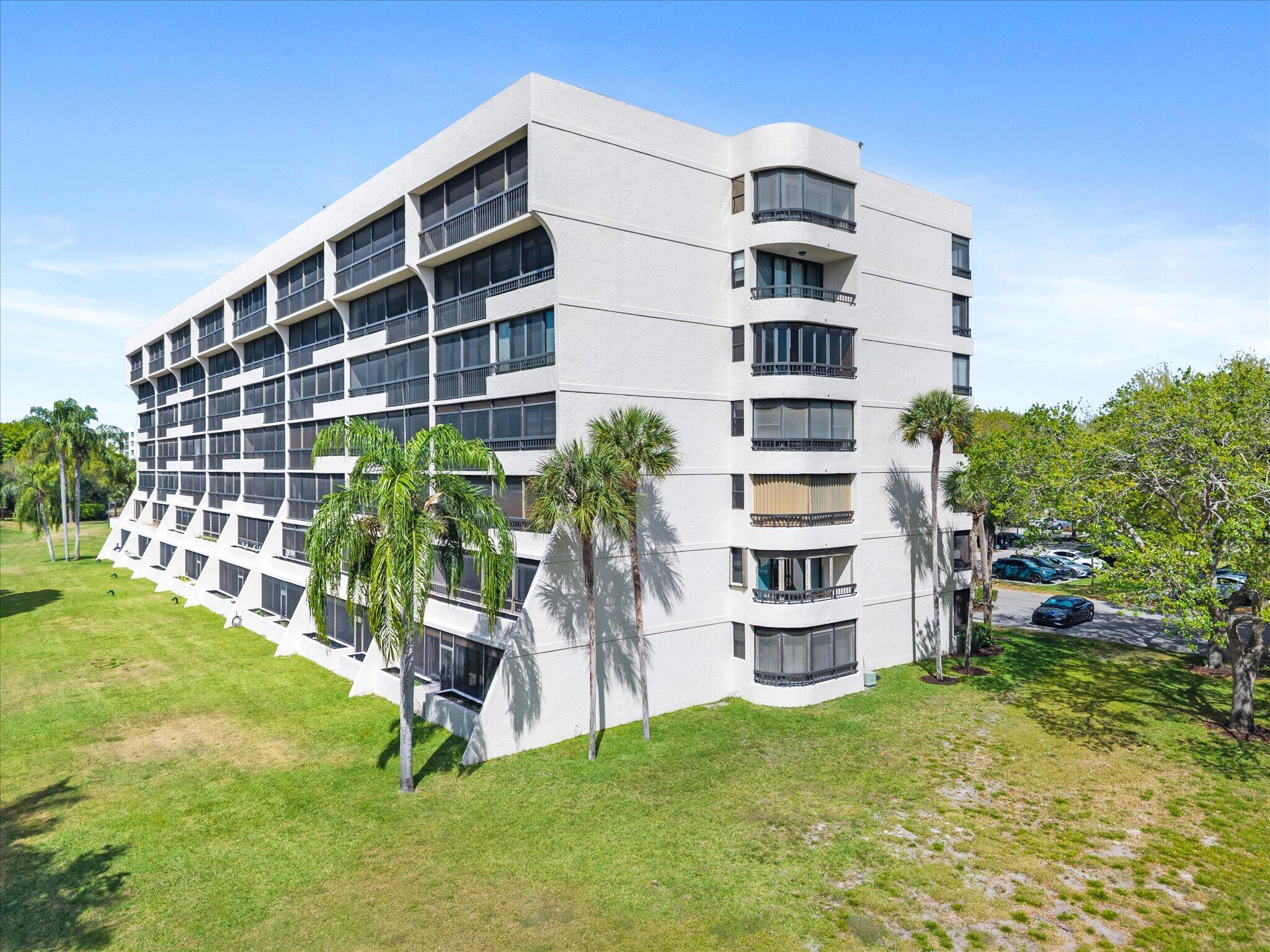 6420 Boca Del Mar Drive, Unit 201 Boca Raton, FL 33433 - Photo 39 of 45 a front view of a building with a garden