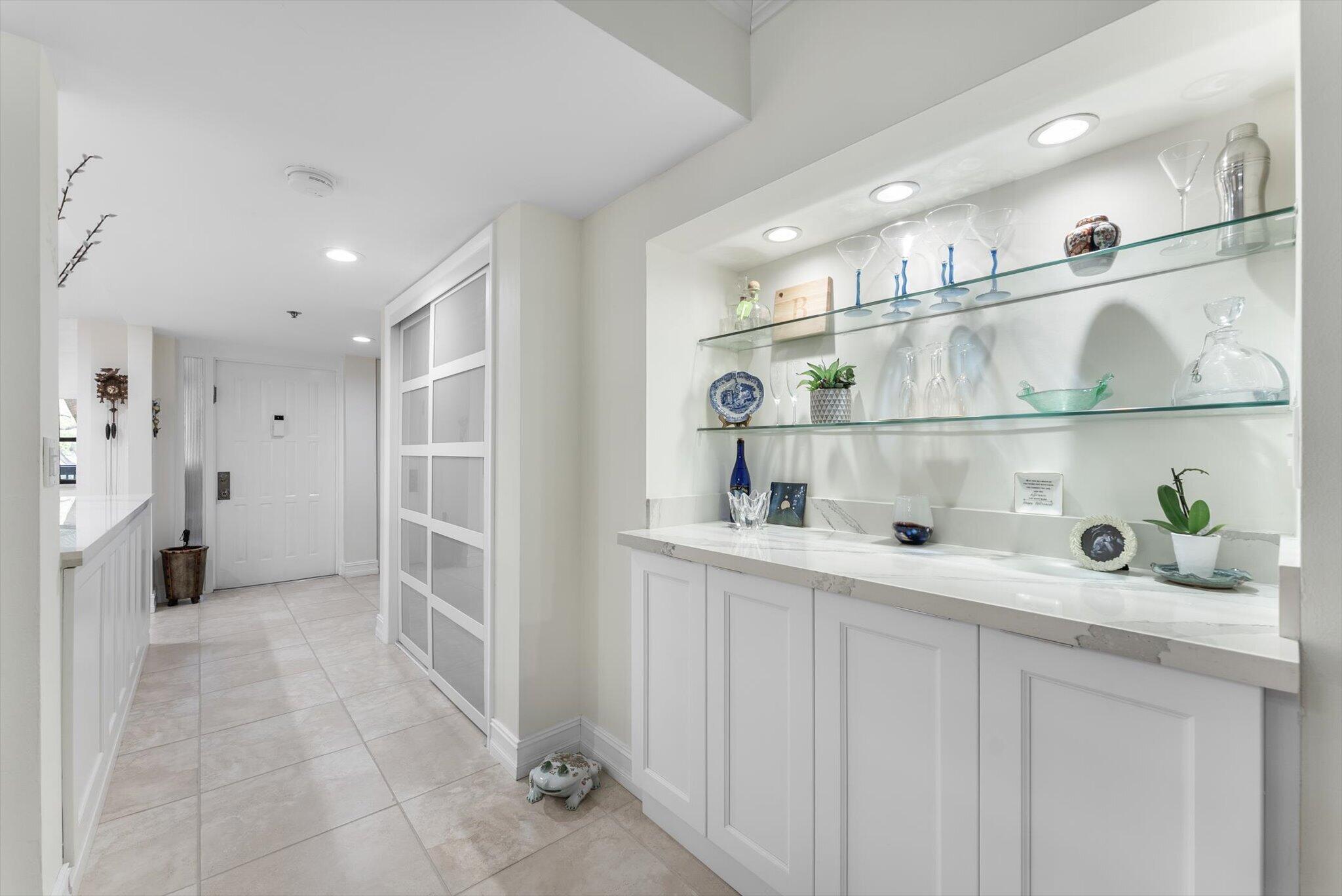 6420 Boca Del Mar Drive, Unit 201 Boca Raton, FL 33433 - Photo 5 of 45 a kitchen with white cabinets and refrigerator