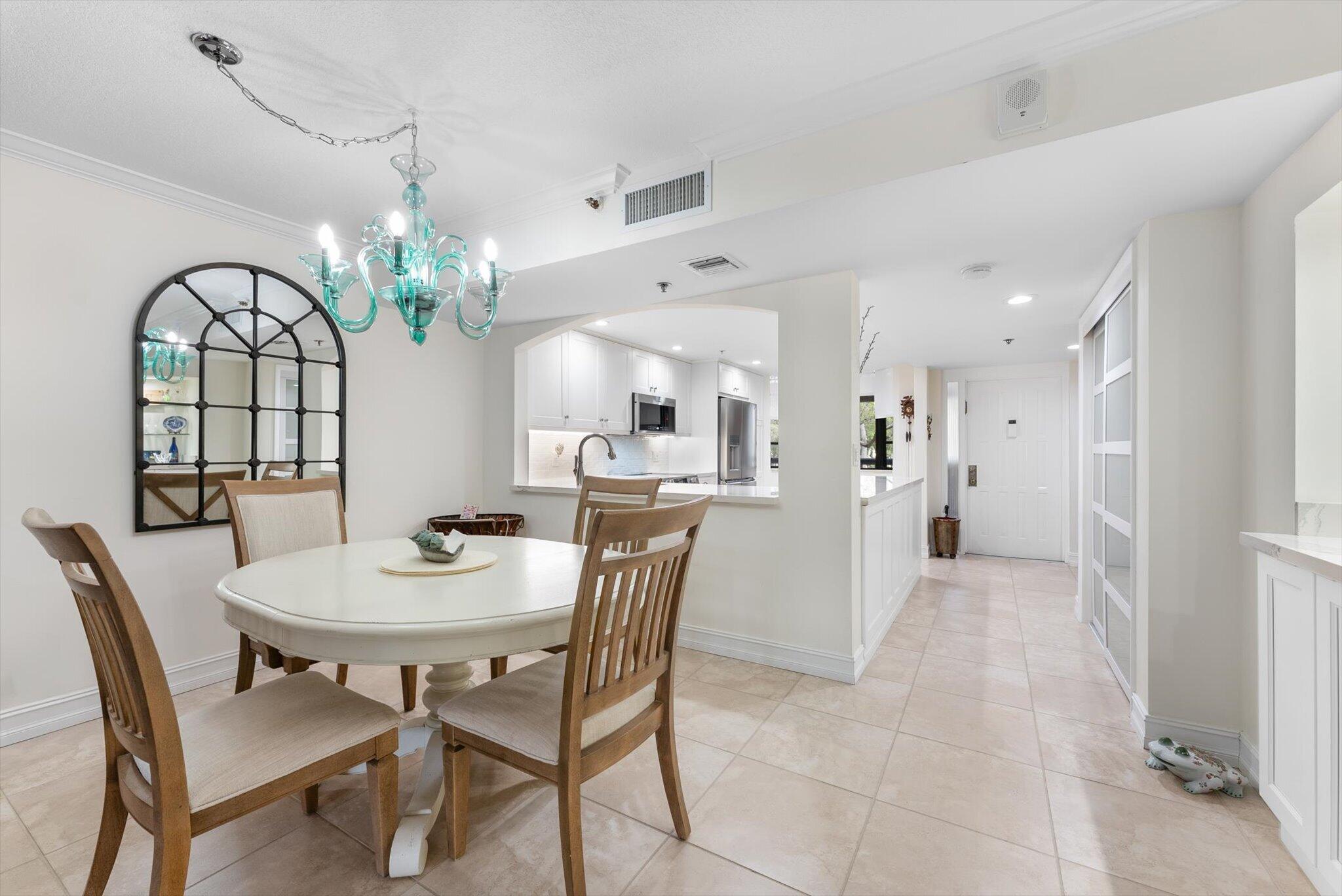 6420 Boca Del Mar Drive, Unit 201 Boca Raton, FL 33433 - Photo 6 of 45 a view of a dining room with furniture and chandelier