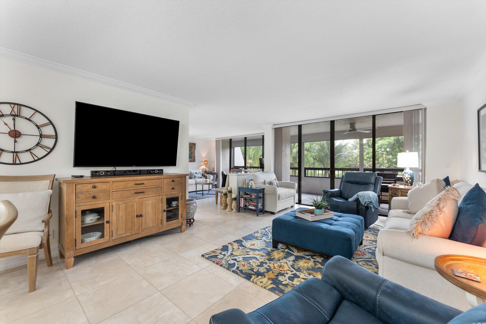 6420 Boca Del Mar Drive, Unit 201 Boca Raton, FL 33433 - Photo 8 of 45 a living room with furniture and a flat screen tv