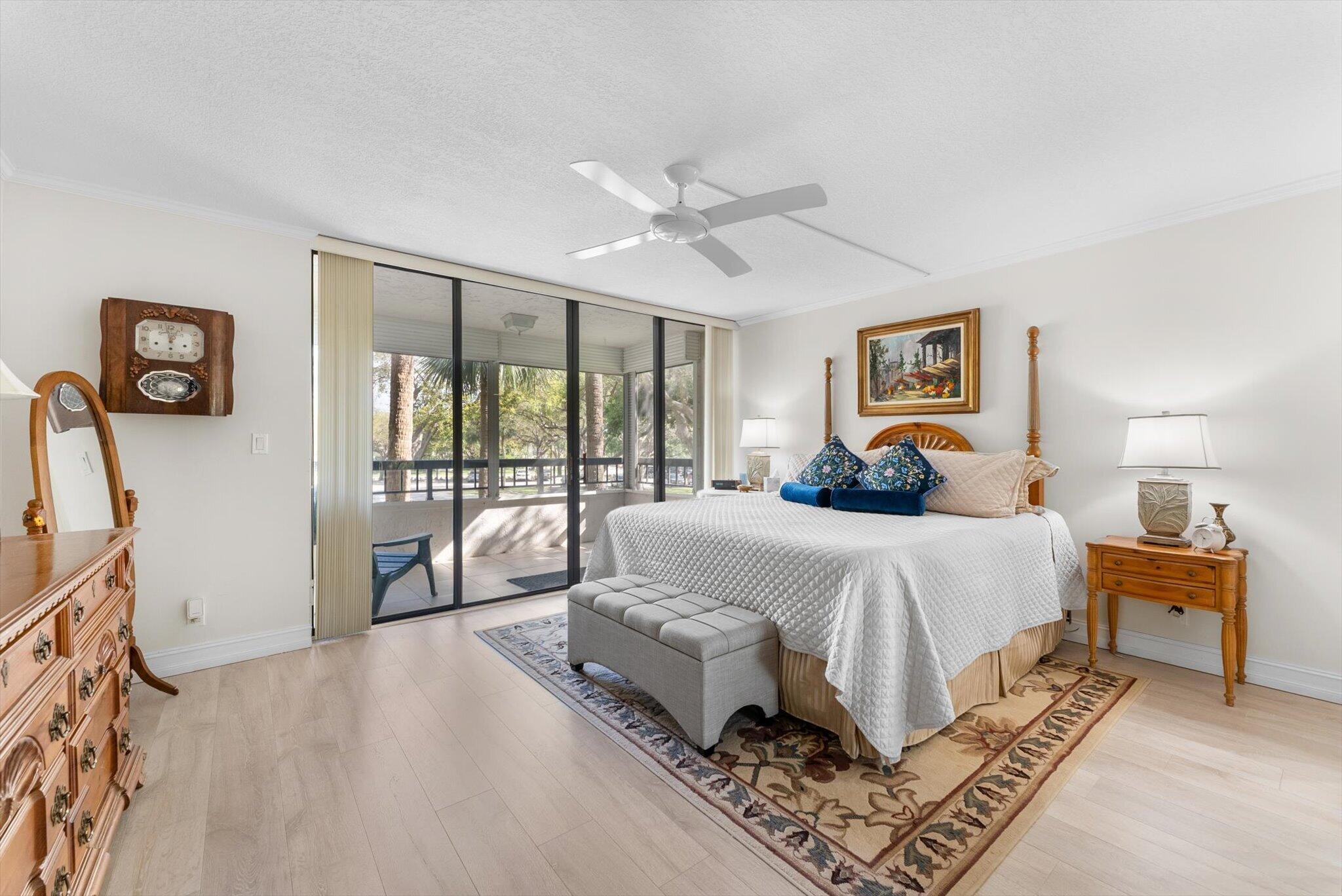 6420 Boca Del Mar Drive, Unit 201 Boca Raton, FL 33433 - Photo 9 of 45 a spacious bedroom with a bed and a large window