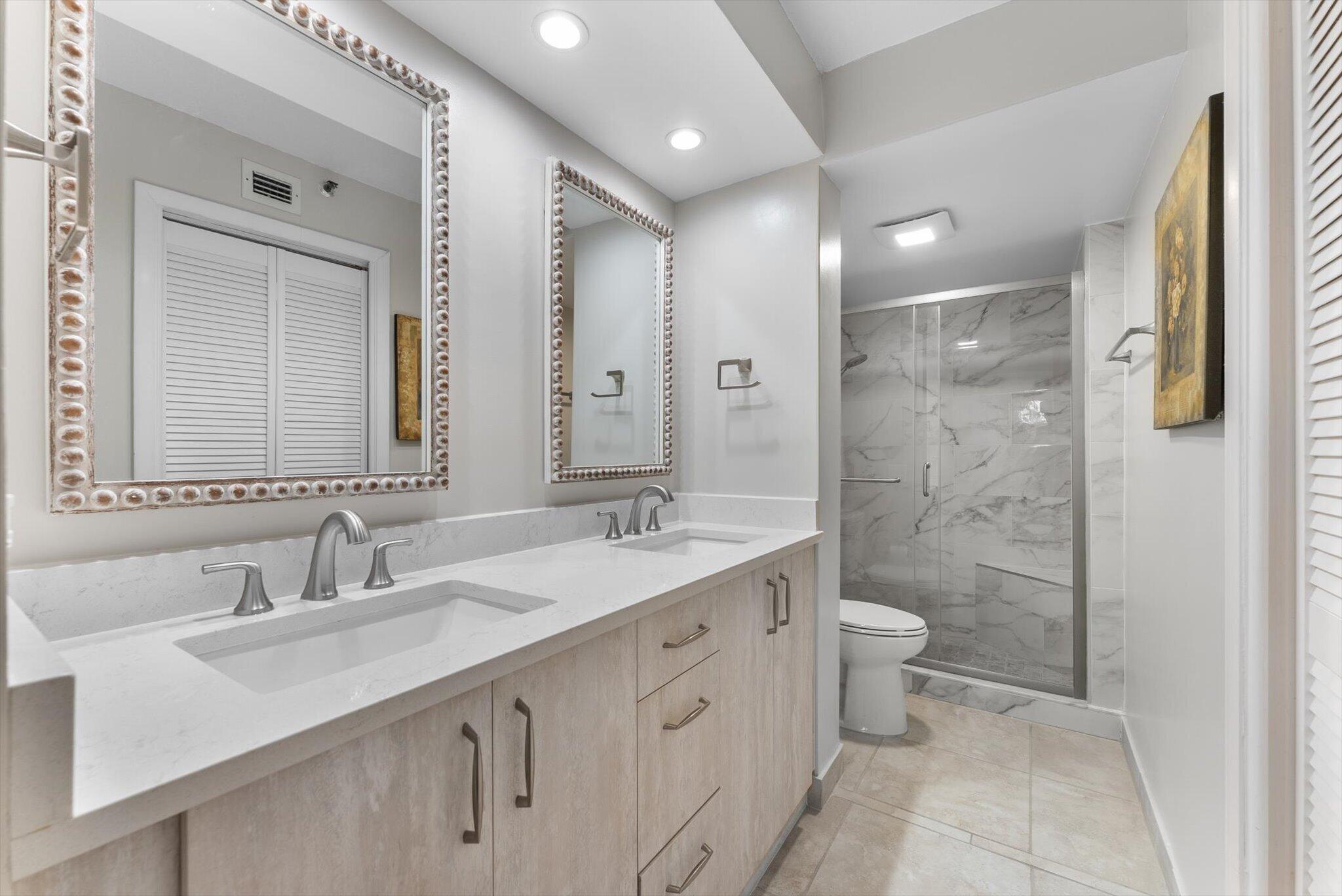 6420 Boca Del Mar Drive, Unit 201 Boca Raton, FL 33433 - Photo 10 of 45 a bathroom with a double vanity sink mirror double shower and a bathtub