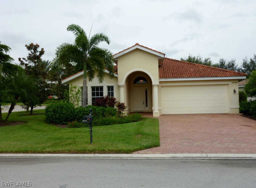 19744 Villa Rosa Loop Fort Myers, FL 33967 - Photo 1 of 14 a front view of a house with a yard and garage