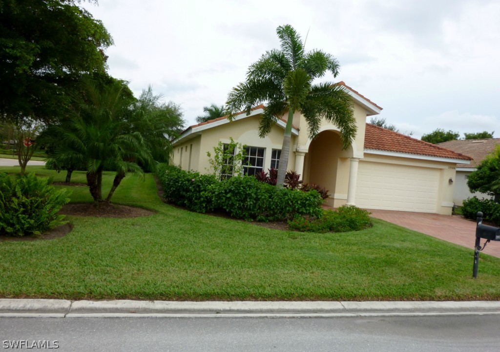 19744 Villa Rosa Loop Fort Myers, FL 33967 - Photo 14 of 14 a front view of a house with a yard and garage