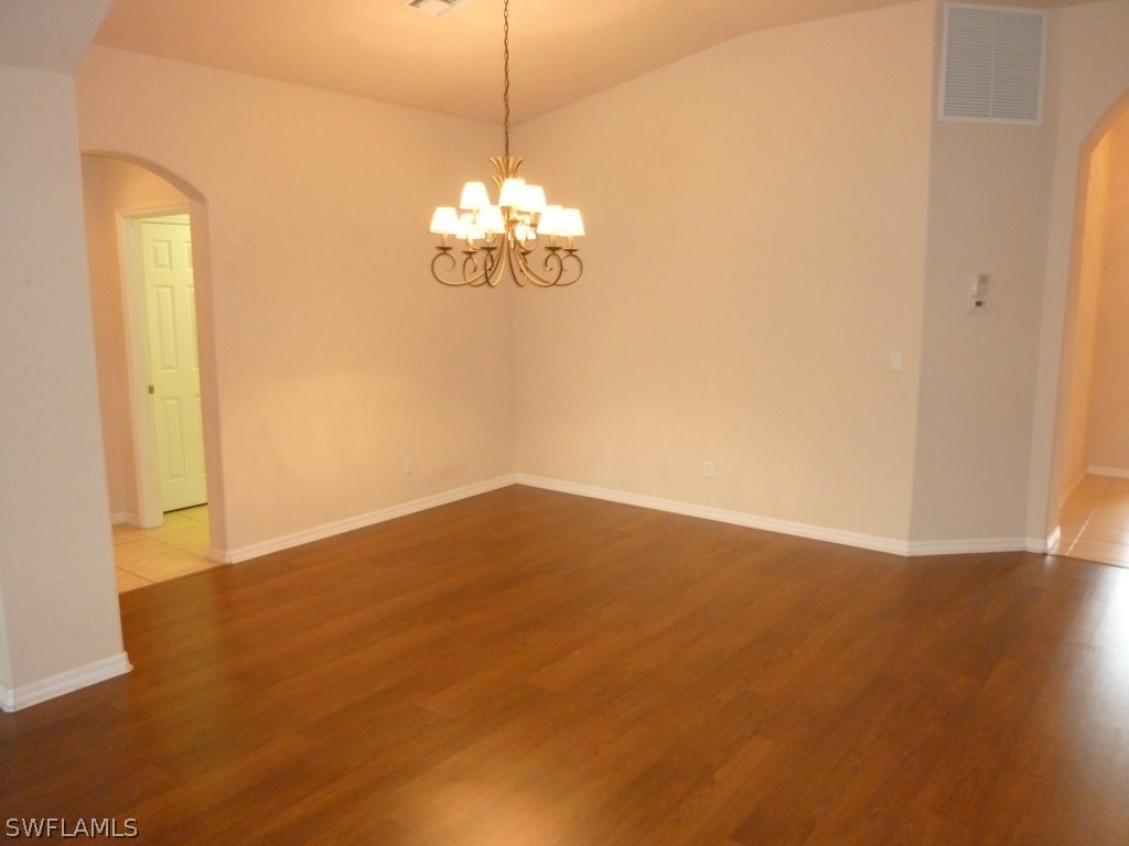 19744 Villa Rosa Loop Fort Myers, FL 33967 - Photo 3 of 14 a view of a big room with wooden floor and chandelier