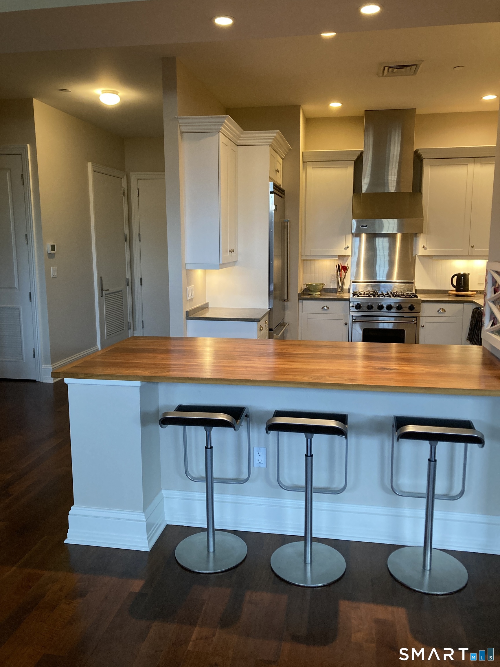 75 Stone Ridge Way, Unit 3A Fairfield, CT 06824 - Photo 5 of 27 a kitchen with stainless steel appliances granite countertop a sink and a cabinets