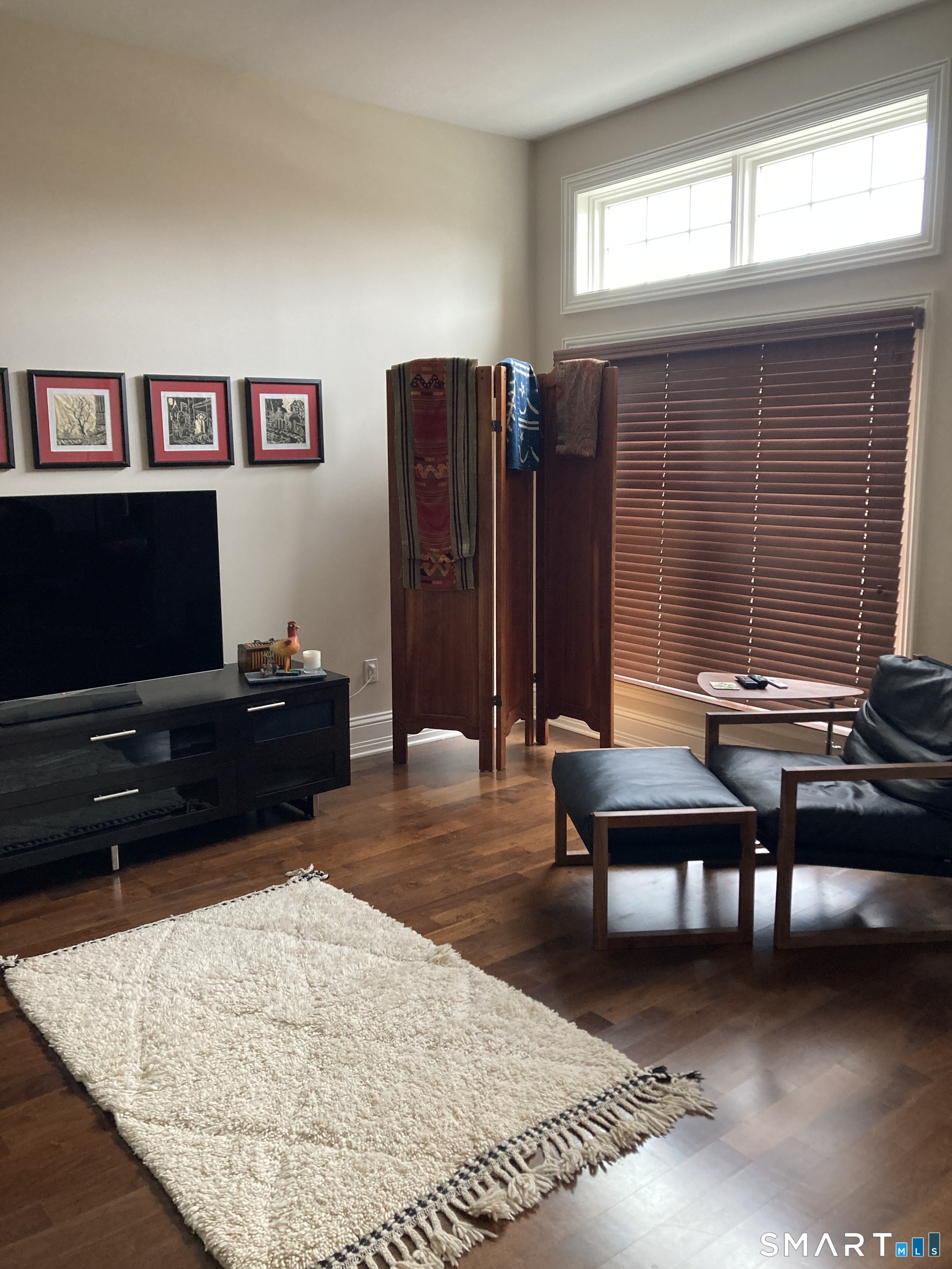 75 Stone Ridge Way, Unit 3A Fairfield, CT 06824 - Photo 7 of 27 a living room with furniture a flat screen tv and a window