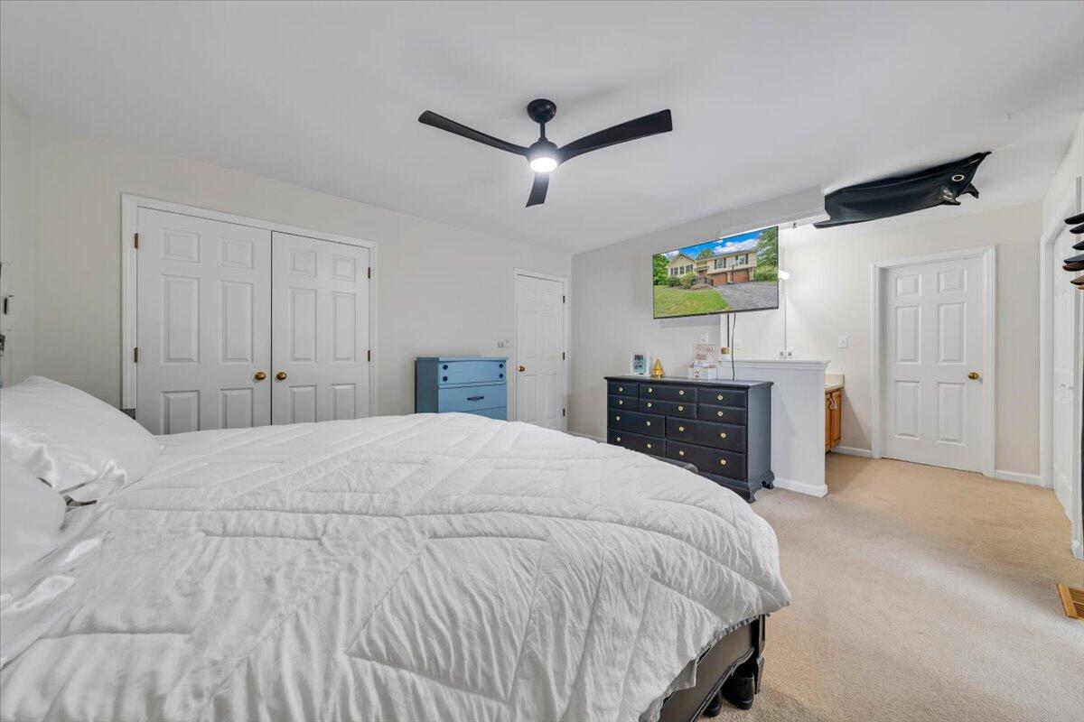 7851 Cedar Edge Road Roanoke, VA 24018 - Photo 16 of 44 a spacious bedroom with a bed and a flat screen tv