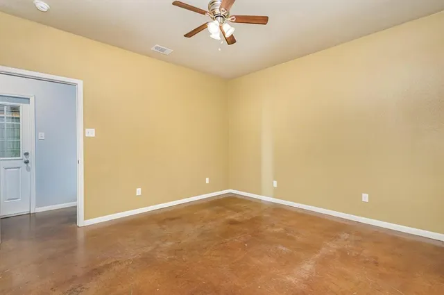 an empty room and a ceiling fan view