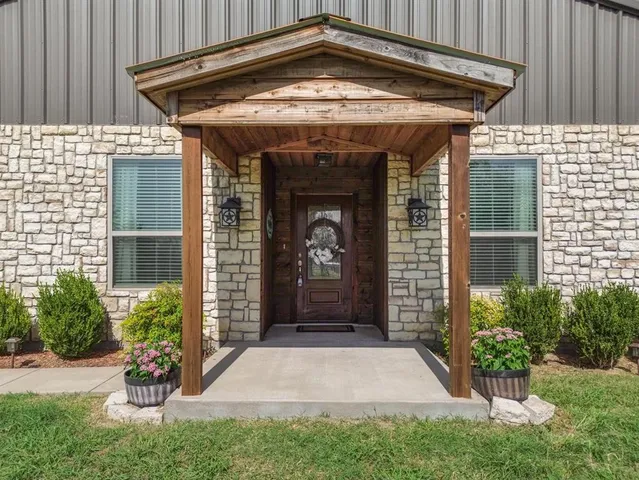 a front view of a house with a garden