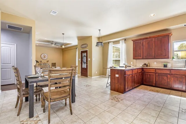 a large kitchen with a table and chairs