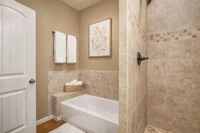 a bathroom with a bathtub and shower