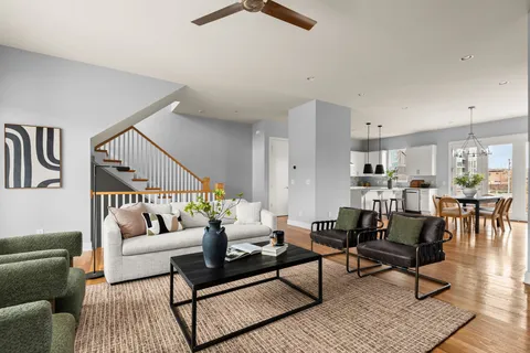 a living room with furniture and wooden floor
