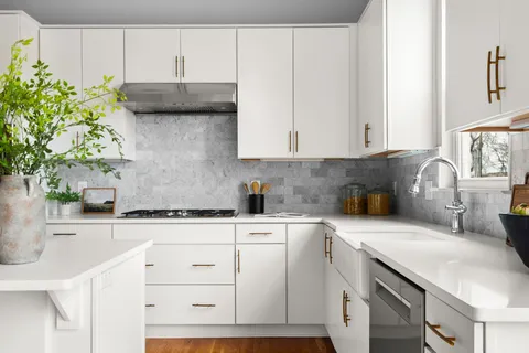 a kitchen with stainless steel appliances white cabinets and a sink