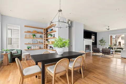 a living room with furniture and a book shelf