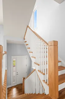 a bedroom with a bed and glass walk in closet