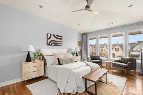 a bedroom with furniture and a large window