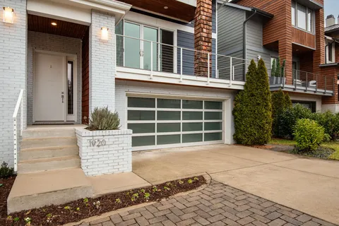 a front view of a building with a garden