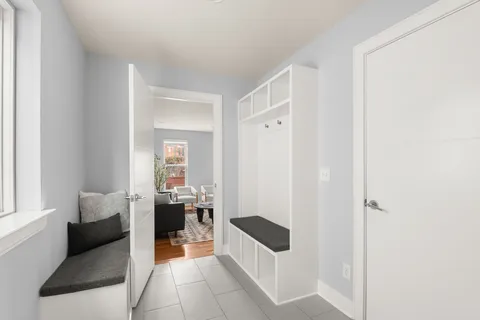 a living room with furniture a rug and a window