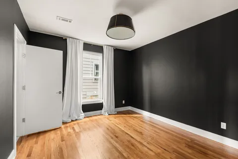 a view of a balcony with wooden floor and fence