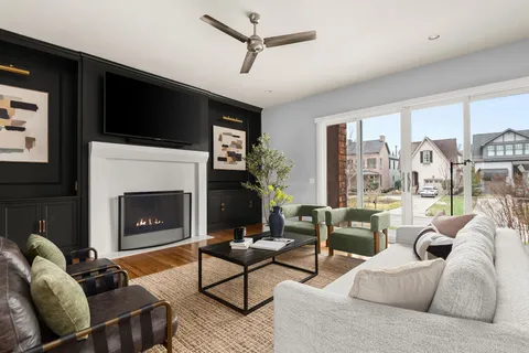 a living room with furniture a flat screen tv and a fireplace