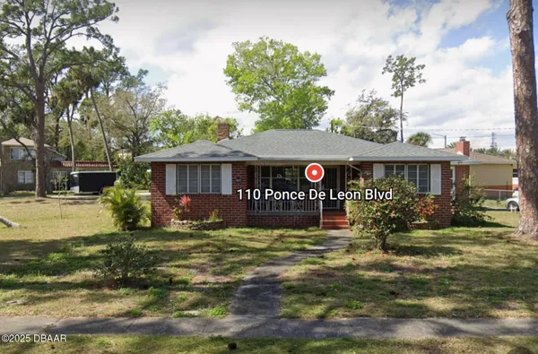 a front view of a house with garden and porch