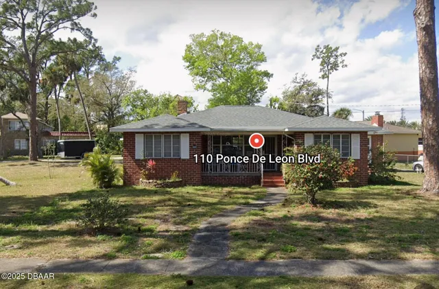 a kitchen with stainless steel appliances kitchen island granite countertop a table chairs sink and cabinets