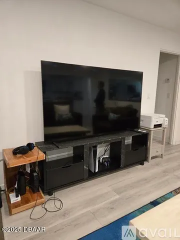 a living room with a flat screen tv and a couch