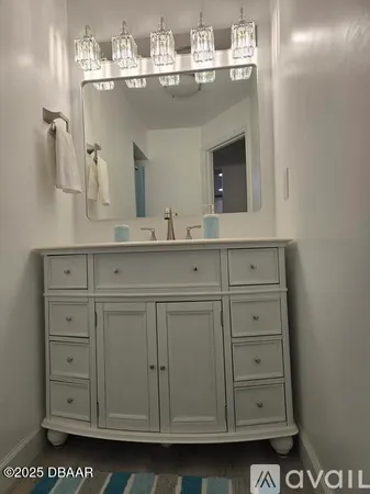 a bathroom with a sink mirror and vanity