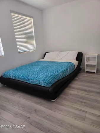 a view of a closet with wooden floor