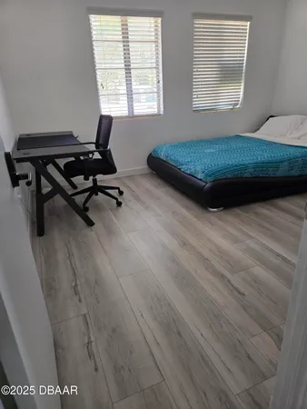 a kitchen with stainless steel appliances granite countertop a table chairs sink refrigerator and microwave