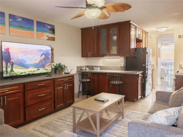 a kitchen with a stove a refrigerator and a microwave